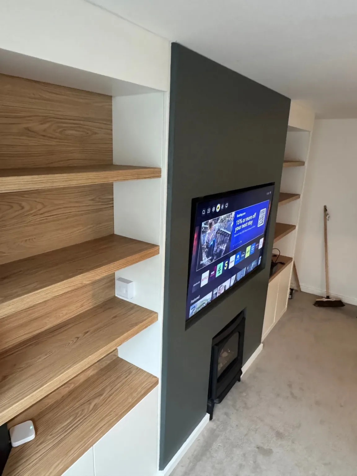 Oak shelving and integrated cabinets in the finished Canton media wall