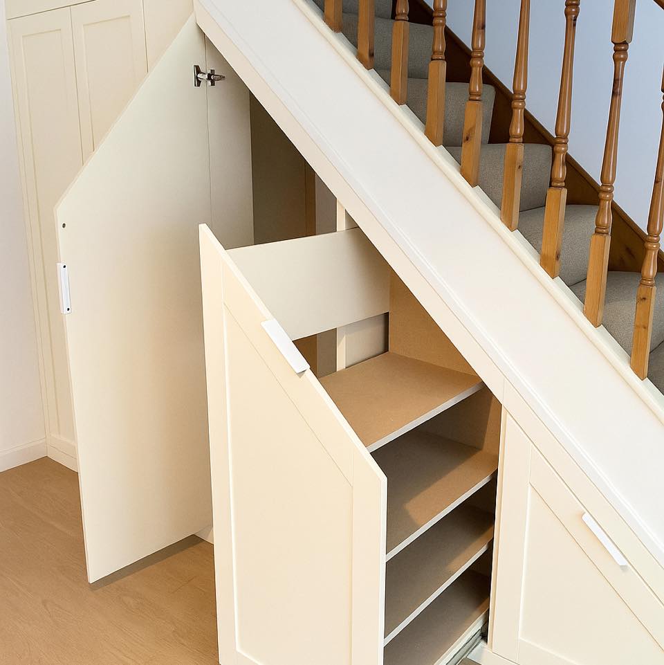 Large bespoke under stairs storage unit in Cardiff wrapping around multiple steps