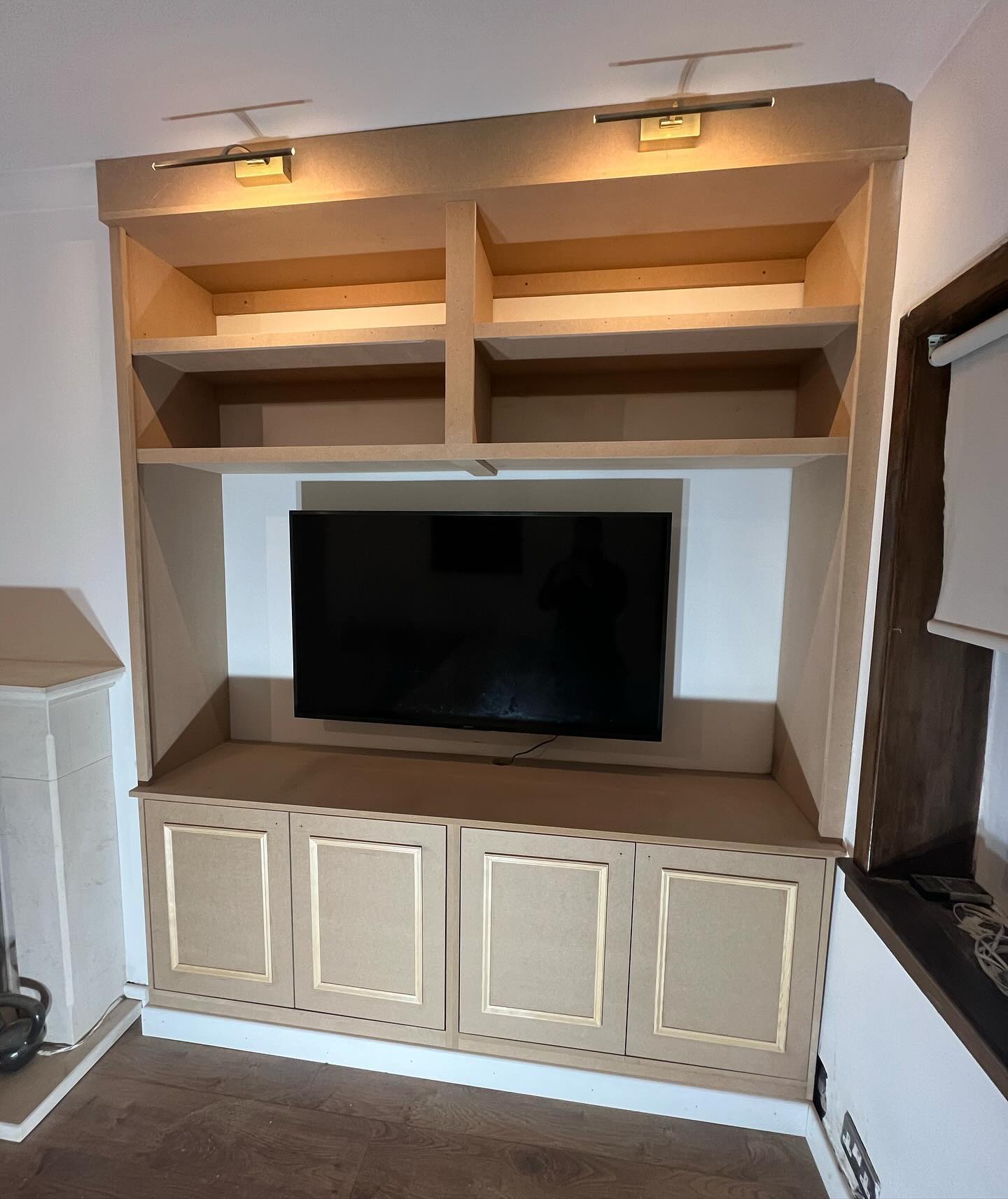 Living room alcove storage integrating AV equipment and display items