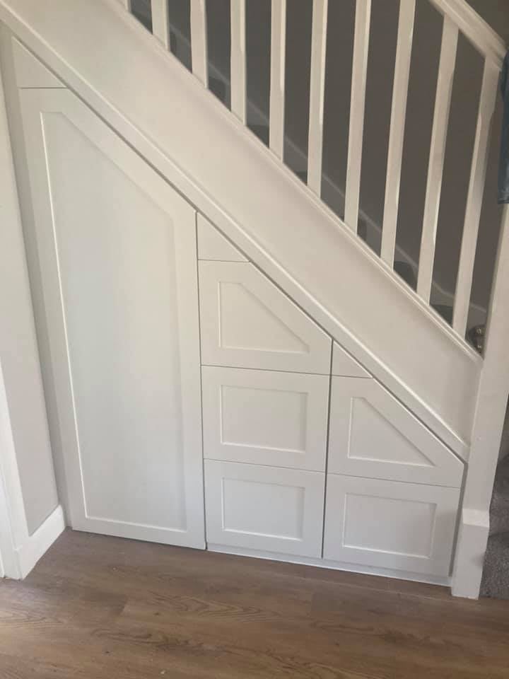 Under stairs storage finished with traditional painted shaker trim doors